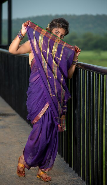 Image of Indian traditional Beautiful Woman Wearing an traditional Saree  And Posing On The Outdoor With a Smile Face-DS712592-Picxy